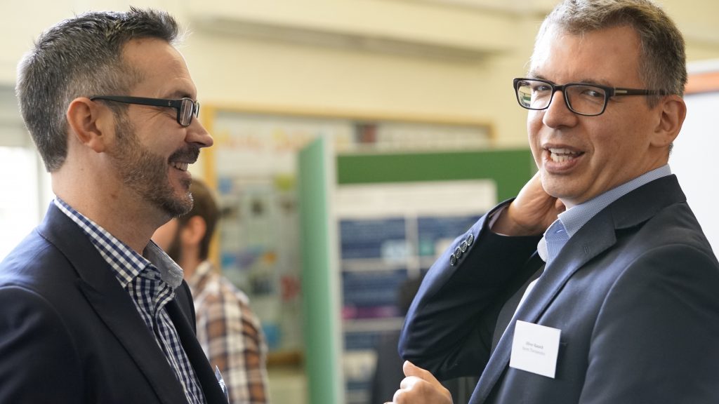 Two attendees networking at the 2017 Milner Symposium